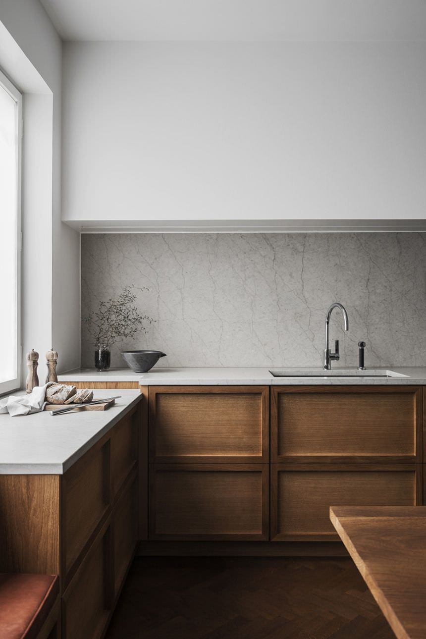 آشپزخانه مینیمال با کابینت های چوبی مدرن که در آن برای حفظ سطوح مسطح، از دستگیره توکار استفاده شده است